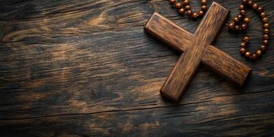 Wooden cross with rosary beads displayed on rustic wooden table creating a calm and reflective atmosphere photo