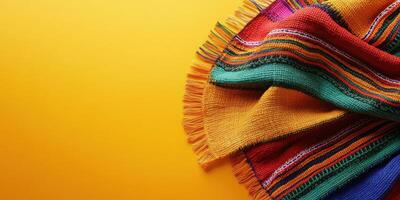 Colorful woven blanket draped on vibrant background showcasing traditional craftsmanship and textile art photo