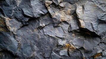 The image is of a rocky surface with a lot of cracks and crevices photo