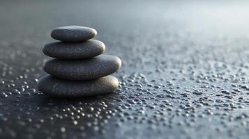 A stack of four rocks on a wet surface photo