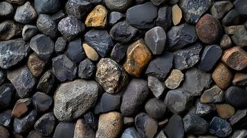 A close up of a pile of rocks with some of them being black photo