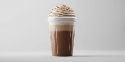 Creamy coffee beverage topped with whipped cream and flavoring in a clear cup photo