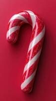 Bright red and white candy cane displayed on a festive background for holiday celebrations photo