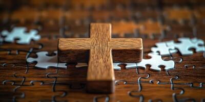 Wooden cross placed on a partially completed jigsaw puzzle representing faith and spirituality challenge photo