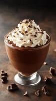 Delicious chocolate mousse topped with whipped cream and chocolate shavings ready to be enjoyed after a meal photo