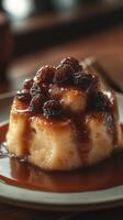 Savory dessert with caramel sauce and raisins served on a white plate in a cozy setting photo