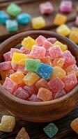 Colorful gummy candies in a wooden bowl on a rustic table surrounded by scattered sweets photo