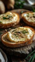 Freshly prepared bread slices topped with creamy spread and herbs on rustic wooden table photo