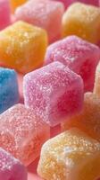 Colorful sugar-coated gummies arranged closely together on a bright surface photo