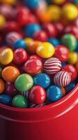 Colorful candies in a red container create a festive atmosphere during a celebration or party photo
