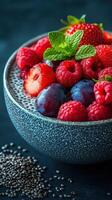 Fresh berries and chia seeds served in a textured bowl for a healthy dessert option photo