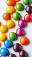 Colorful candy arranged in vibrant patterns on a white background, showcasing a variety of shapes and shades photo