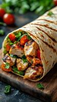 Grilled chicken wrap filled with fresh vegetables and herbs served on a wooden board photo