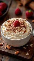 Delicious dessert bowl with whipped cream, nuts, and raspberries set on a wooden table photo
