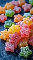 Brightly colored star-shaped candies scattered on a dark surface in a cheerful arrangement photo