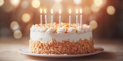 Celebratory cake with candles glowing brightly during a festive gathering in a warmly lit setting photo