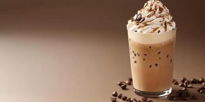 Creamy iced coffee beverage topped with whipped cream and chocolate shavings, served in a clear glass photo
