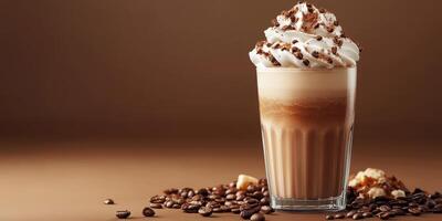 Creamy coffee drink topped with whipped cream and chocolate on a wooden table photo