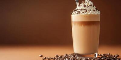 Creamy coffee drink topped with whipped cream and chocolate on a wooden table photo