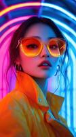 Portrait of a woman in vibrant neon lights wearing oversized yellow sunglasses photo
