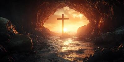 Sunset view of a cave with a cross under a glowing sky by the ocean photo