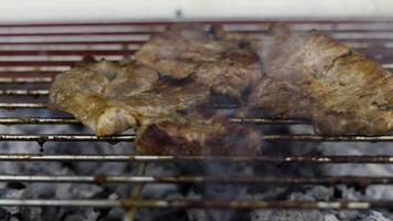 Grilling pork steaks on charcoal grill. Thai style. video