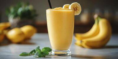 Refreshing banana smoothie served in a tall glass with mint leaves and fresh bananas beside it photo