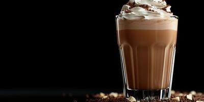 Rich chocolate drink topped with whipped cream served in a glass against a dark background photo