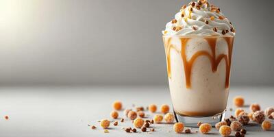 Creamy vanilla dessert topped with whipped cream and caramel sauce on a light gray surface photo