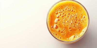 Refreshing orange juice served in a clear glass on a light background with bubbles and foamy texture photo