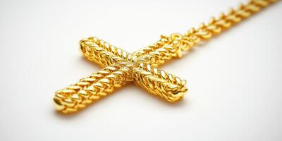Golden cross necklace with intricate chain design displayed on a neutral background photo