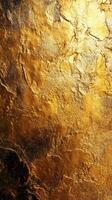 Golden textured surface with intricate patterns in warm hues illuminated by soft light photo