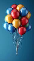 Colorful balloons floating against a blue background create a festive atmosphere for celebrations and events photo