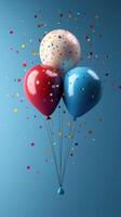 Colorful balloons adorned with confetti float against a blue background for a festive celebration photo