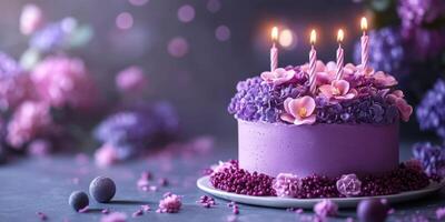 Beautiful purple floral cake with candles celebrating a special occasion photo