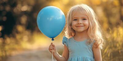 Child with a blue balloon enjoys a sunny outdoor moment on a warm day in nature photo
