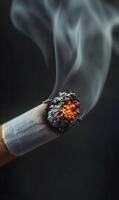 Illuminated cigarette ember emitting wisps of smoke against a stark backdrop, a close up photo