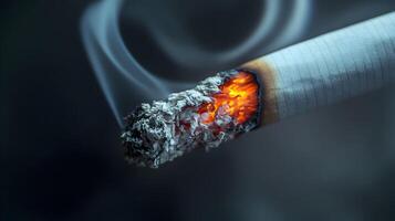 Close-up of a Lit Cigarette with Glowing Tip and Rising Smoke Against a Dark Backdrop photo