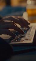 Hands typing on glowing keyboard, close-up capture of focused work on a modern laptop photo