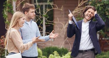 Annoyed clients arguing with irritated real estate agent about property purchase, outside photo