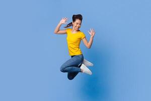 Crazy Sales. Funny Asian Girl Jumping In Air On Purple Background And Posing At Camera With Raised Hands, Free Space photo