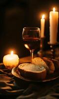 Atmospheric Still Life Depicting Bread, Wine, and Candles in a Golden Light Ambiance photo