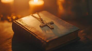 Illuminated book with golden cross and candlelight, signifying faith and dedication photo
