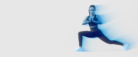 A woman dressed in a black sports bra top and leggings is demonstrating a yoga pose. She appears focused and balanced as she engages in the mindfulness practice. photo