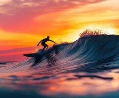 Surfer riding a wave at sunset on a calm ocean photo