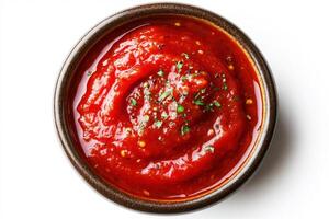 Homemade tomato sauce with fresh herbs in a brown bowl photo