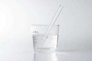 Clear liquid in a laboratory beaker with a glass stirring rod photo