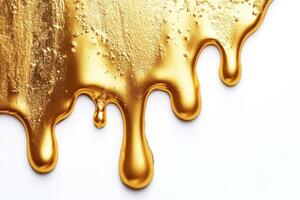 Liquid gold drips elegantly on a white surface photo
