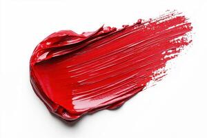 Vibrant red paint stroke on a clean white surface photo