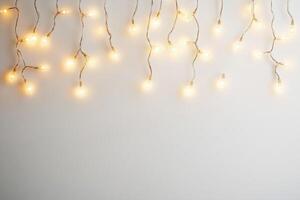 Warm glowing fairy lights hanging against a neutral background photo